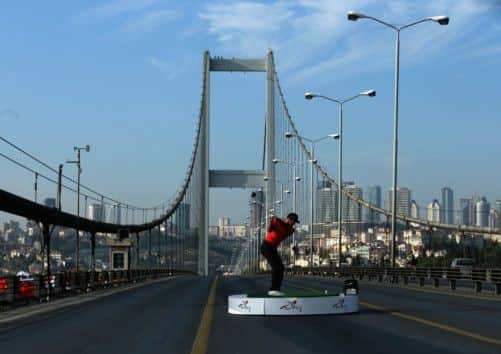 Tiger Woods makes history yesterday with the first golf shots from east to west on Istanbuls iconic Bosphorous Bridge. Picture: Getty