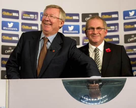 Sir Alex Ferguson and SFA vicepresident Alan McRae make the draw for the fourth round of the Scottish Cup yesterday. Picture: SNS