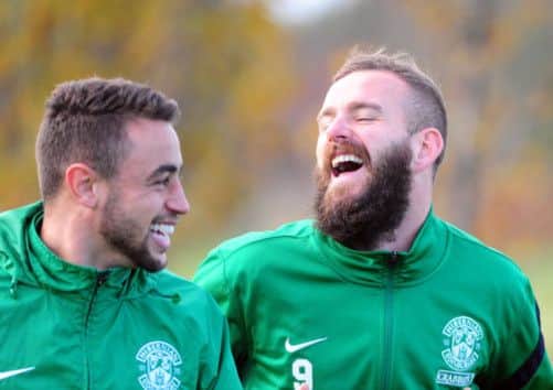 Tom Taiwo, left, and Rowan Vine share a joke at Hibs training at East Mains yesterday. Picture: Ian Rutherford
