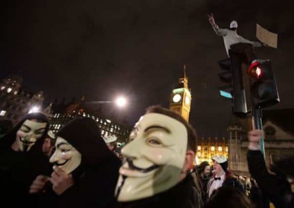 Protesters demonstrate as part of the Bonfire of Austerity protest outside the Houses of Parliament in central London. Picture: PA