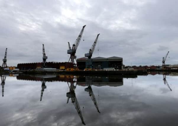 Cranes are reflected in the River Clyde at BAE Systems in Govan. Picture: PA