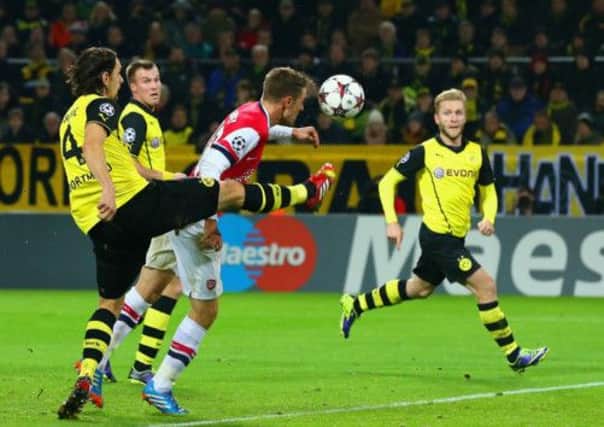 Neven Subotic of Borussia Dortmund fails to stop Aaron Ramsey from scoring for Arsenal. Picture: Getty