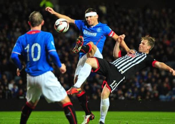Lee McCulloch of Rangers and Jordan Moore of Dunfermline battle for the ball. Picture: Getty
