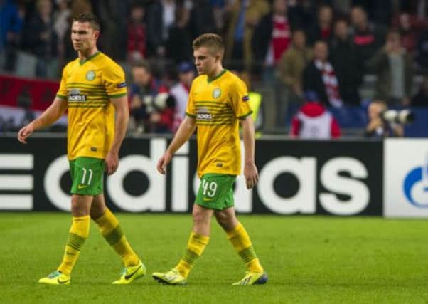 Celtic's Derk Boerrigter and James Forrest trudge off the pitch at full-time following last night's Champions League defeat. Picture: SNS