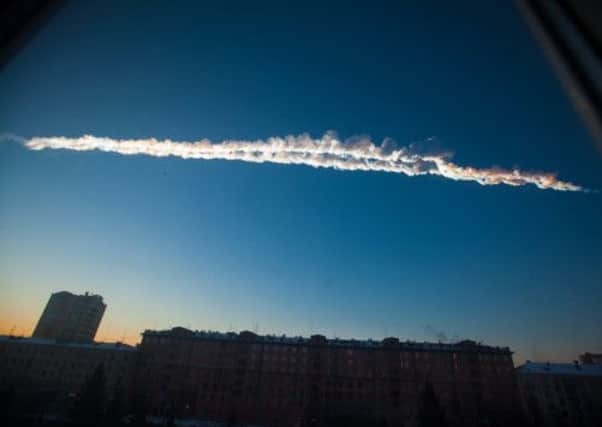 A meteorite contrail over Chelyabinsk in February this year. The meteor itself smashed windows and injured thousands of people. Picture: AP