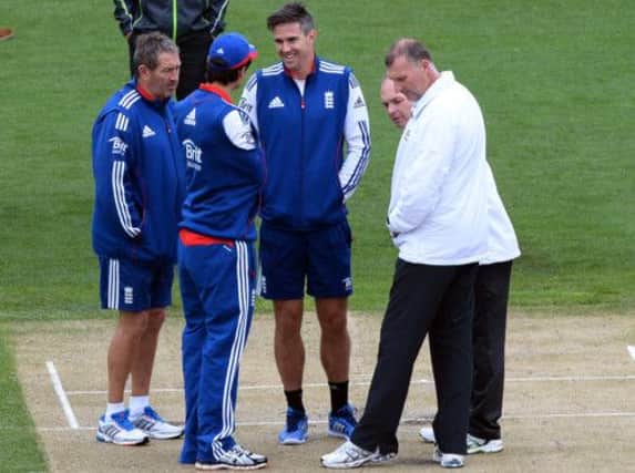 England players chat as rain forces the abandonment of the second day of Australia A v England. Picture: AFP/Getty