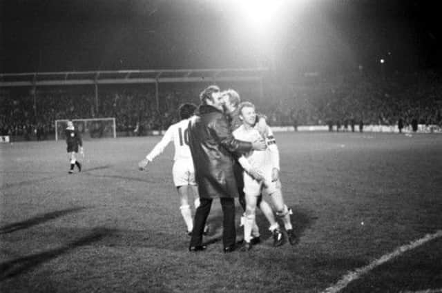 Leeds United manager Don Revie joins his players, including Billy Bremner, right, on the Easter Road pitch. Picture: TSPL