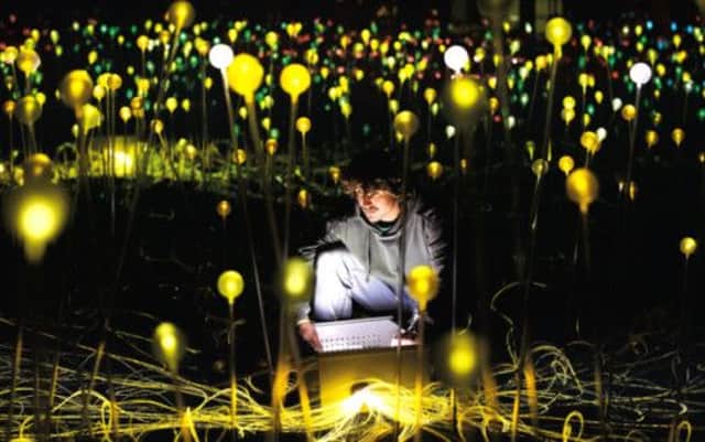 Ed Manders makes adjustments to Bruce Munro's Field of Light installation in the grounds of Holbourne Museum, Bath, in 2011. Picture: Getty