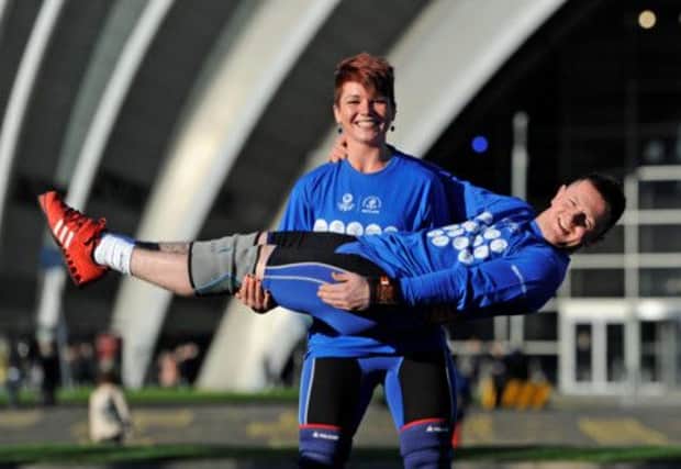 Georgi Black shows her strength with the help of team-mate Craig Carfray at the Clyde Auditorium. Picture: HEMEDIA