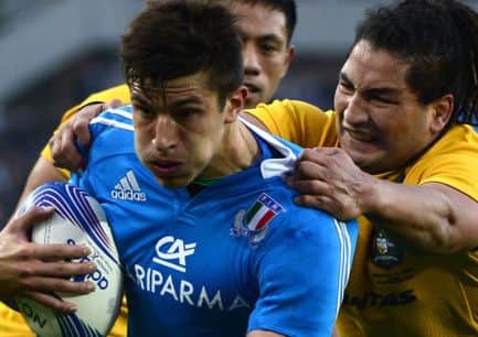 Shouldering responsibility: Australias Saia Faingaa seems keener on the jersey than the ball in Tommaso Allans hands. Picture: Getty
