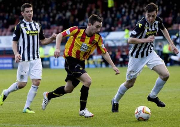 Partick's Steven Lawless is marked by Kenny McLean (left) and Sean Kelly. Picture: SNS