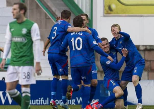 Jubilation for Billy McKay who celebrates scoring Inverness' second but dejection for Hibernian's Kevin Thomson. Picture: SNS