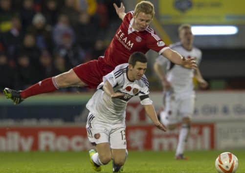 Barry Robson fouls Jason Holt, earning his second yellow and changing the game. Picture: SNS