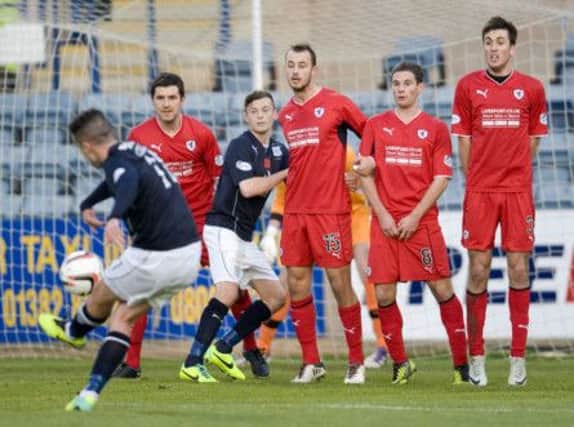 Sweet spot: Ryan Conroy makes perfect contact with a free kick to curl home Dundees opening goal. Picture: SNS