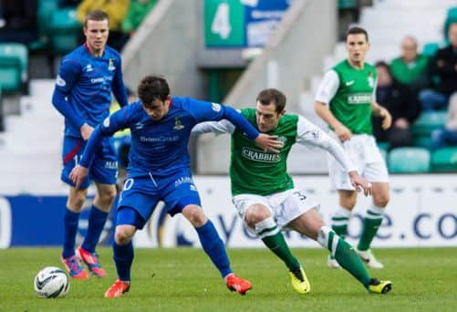 Inverness forward Aaron Doran holds off the attentions of Hibs midfielder Kevin Thomson. Picture: Ian Georgeson