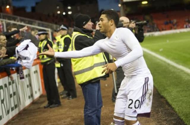Hearts player Callum Tapping throws his shirt, commemorating McCraes Battalion, into the Hearts supporters. Picture: SNS