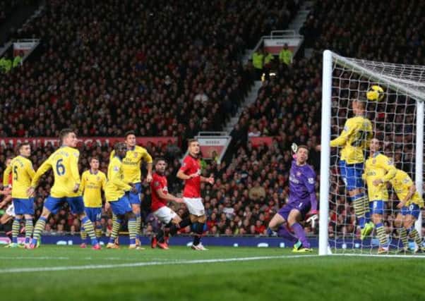 From a Wayne Rooney corner, Manchester Uniteds Robin van Persie sends his header into the Arsenal net. Picture: PA