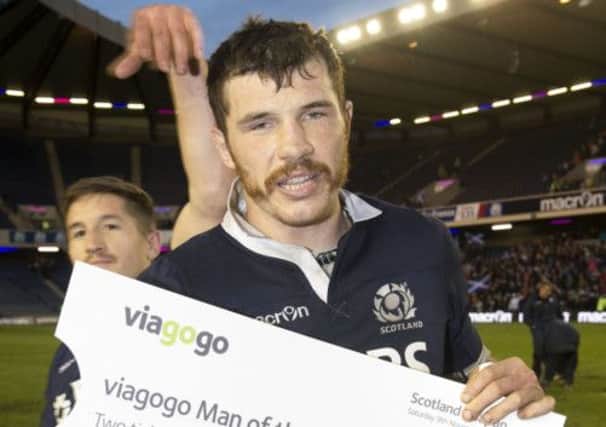 Scotland's Tim Swinson is presented with the Man of the Match award. Picture: SNS/SRU
