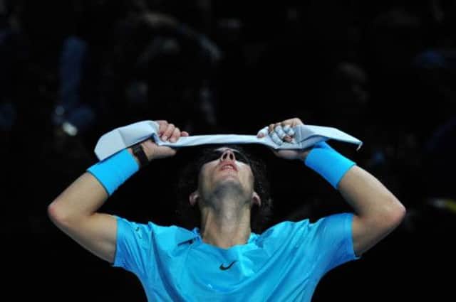 Rafael Nadal reties his headband between points. Picture: Getty
