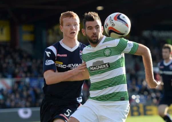 Joe Ledley holds off Ross County's Scott Boyd in Celtic's 4-1 win over The Staggies at the weekend. Picture: SNS