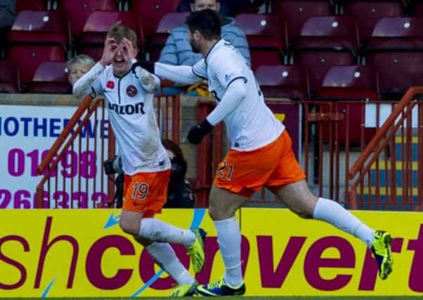 Ryan Gauld wheels away in celebration, with Nadir Ciftci in close pursuit. Picture: SNS