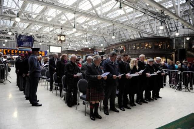 Servicemen and commuters at a  service of Remembrance at Glasgow Central Station. Picture: HeMedia