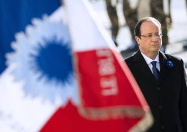 A solemn Francois Hollande at the Arc de Triomphe - he later had to be whisked away. Picture: Getty Images