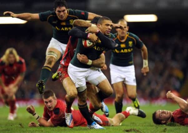 South Africa wing Bryan Habana is tackled by Wales Mike Phillips. Picture: Getty