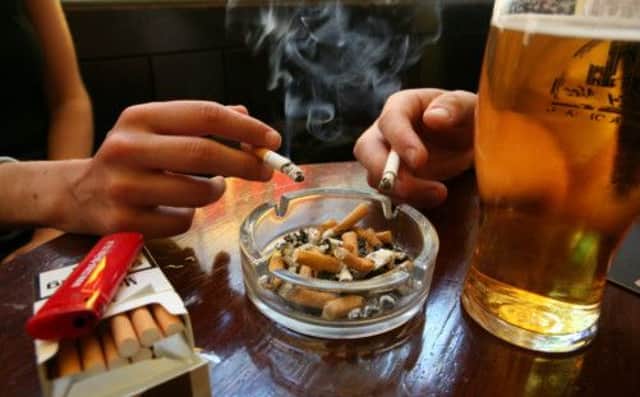 Many of us will have spent time in smoke-filled homes, pubs and workplaces. Picture: Getty Images
