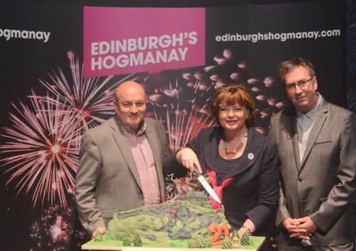 Steve Cardownie, Fiona Hyslop and Pete Irvine cut Edinburgh's Hogmanay 21st birthday cake. Picture: Neil Hanna