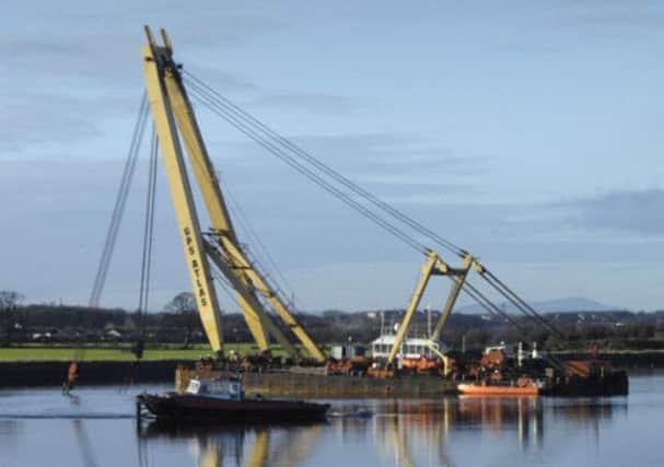 A crew salvage the Flying Phantom, which sank on the River Clyde. Picture: Donald MacLeod