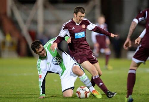 Marcel Schafer (left) tackles Hearts ace Dale Carrick. Picture: SNS