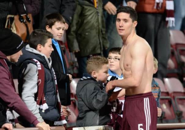 Dylan McGowan rewards Hearts fans backing by giving a lucky youngster his shirt. Picture: Rob Casey/SNS