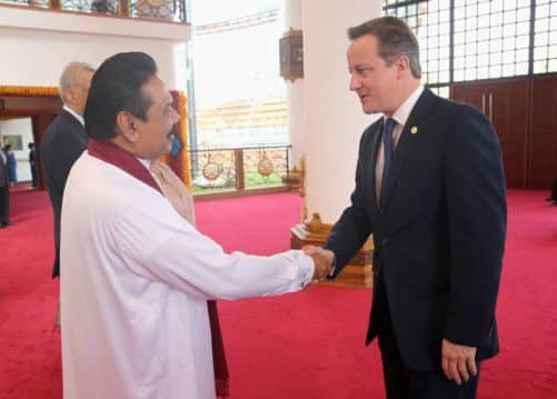 Mahinda Rajapaksa greets David Cameron. Picture: PA