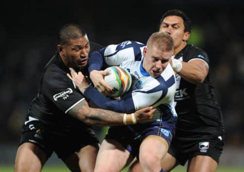 Scotlands Alex Hurst is tackled by New Zealands Frank-Paul Nuuausala (left) and Jesse Bromwich. Picture: PA