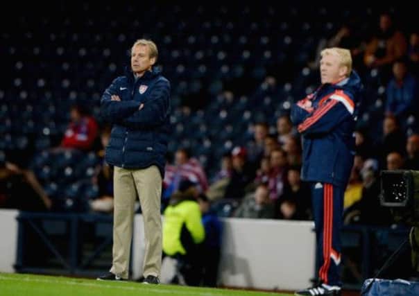 While not as eye-catchingly attired as of yore, USA manager Jurgen Kinsmann, left, still caught the eye on the touchline. Picture: Getty
