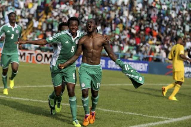 Celtic's Efe Ambrose (No.5) celebrates with a bare-chested Victor Moses after the latter put Nigeria ahead.  Picture: Reuters