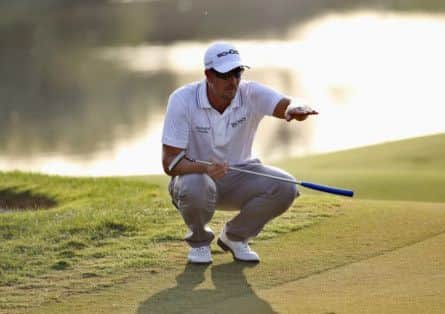 Henrik Stenson lines up the ball for one of his five third round birdies to lead by one shot in Dubai. Picture: Reuters