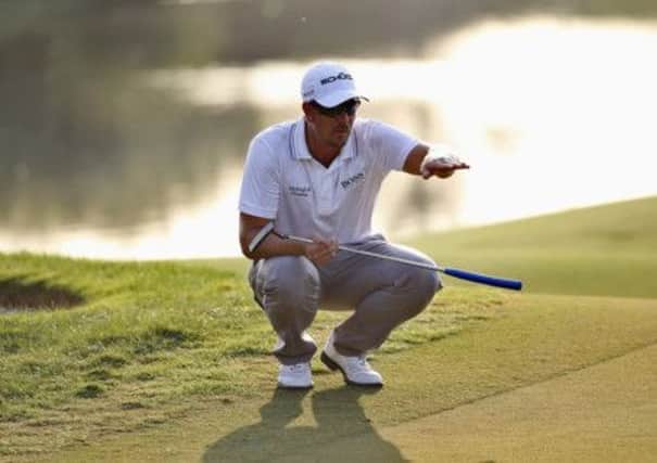 Henrik Stenson lines up the ball for one of his five third round birdies to lead by one shot in Dubai. Picture: Reuters