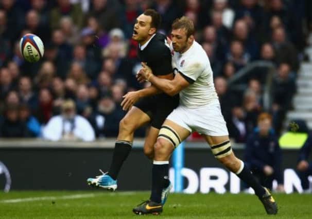 England skipper Chris Robshaw gets to grips with Israel Dagg of New Zealand at Twickenham. Picture: Getty