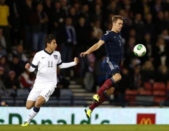 Steven Whittaker gets to the ball ahead of Alejandro Bedoya during Scotland's goalless draw with the United States at Hampden last Friday. Picture: Reuters