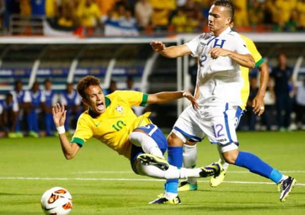 Brazilian forward Neymar takes a tumble in the presence of Rangers and Honduras player Arnold Peralta. Picture: Getty