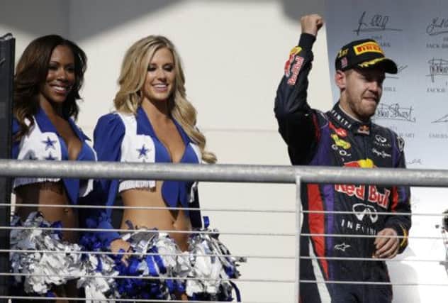 Sebastian Vettel had to walk past some Dallas Cowboy cheerleaders on his way to the podium after winning the United States Grand Prix in Austin, Texas. Picture: AP