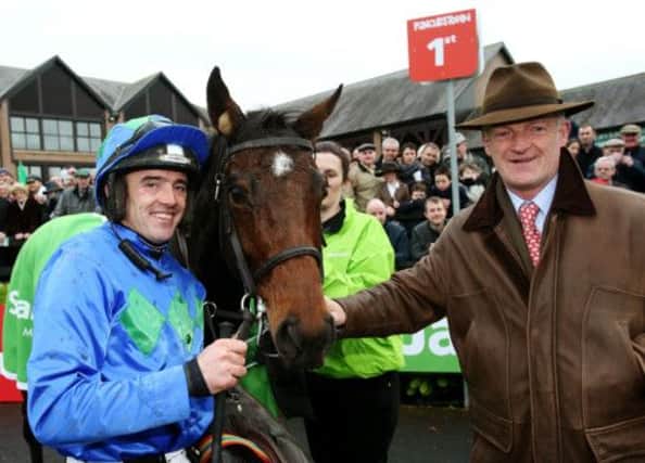 Jockey Ruby Walsh and trainer Willie Mullins with Hurricane Fly in the parade ring after setting a new world record at the Winter Festival at Punchestown. Picture: PA
