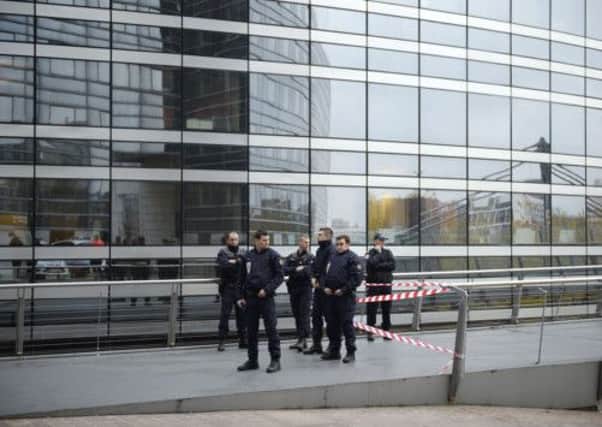 Police stand outside the entrance of the headquarters of the Societe Generale bank in the La Defense business district. Picture: AP