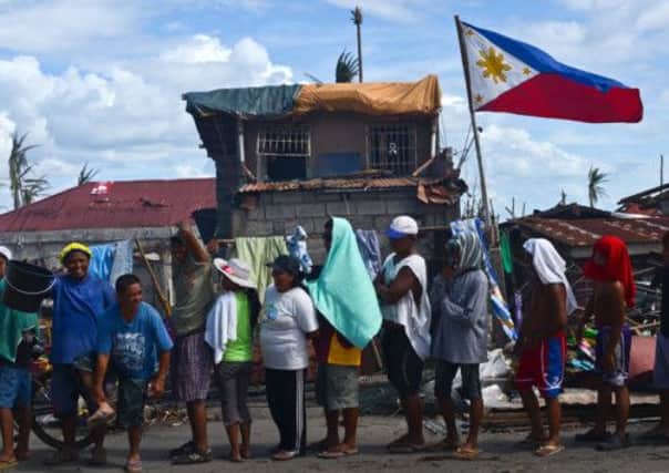 Survivors in a town in Leyte queue for food. It is estimated 4,500 died in the storm, which destroyed the Leyte city of Tacloban.  Picture: Getty