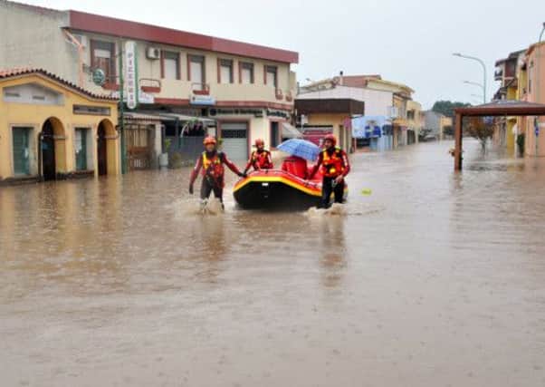 Firefighters work to rescue citizens in Terralba, centre Sardinia after floodwaters devastated the island. Picture: Getty