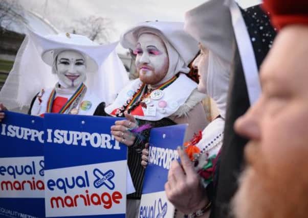 Campaigners from the Equality Network hold a rally outside the Scottish Parliament. Picture: Getty