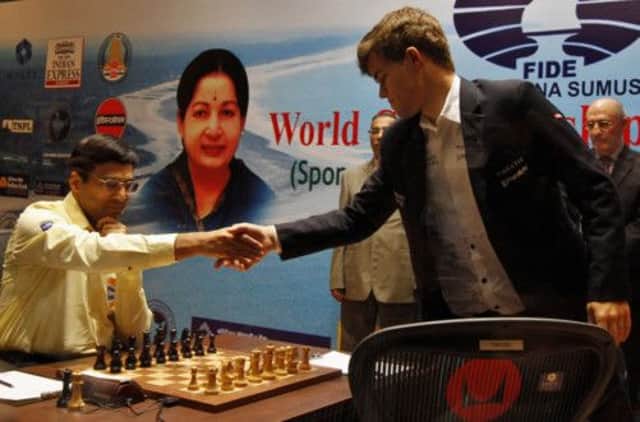 Viswanathan Anand, 43, shakes hands with Magnus Carlsen after the young Norwegian triumphed in Anand's hometown yesterday. Picture: AP