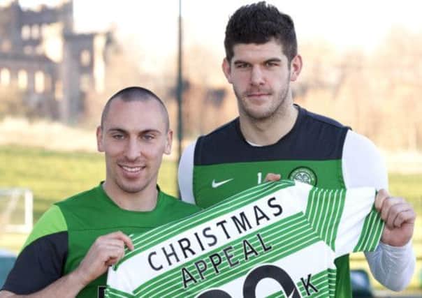 Captain Scott Brown, left, has been told to tone down his aggression as the player launched the club's Christmas charity appeal with Fraser Forster. Picture: SNS